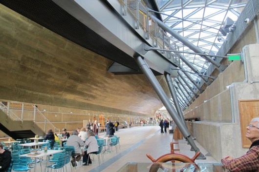 On the floor of the dry dock we look forward to the bow. In the distance the superb figurehead collection. And yes - refreshments in the foreground. 